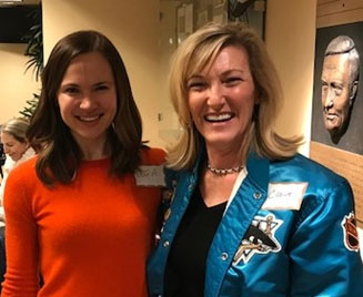 Photo of Claire and a team member at a San Jose Shark's party